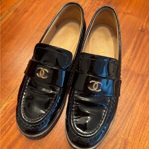 CHANEL Glossy Black Loafers with Gold Logo